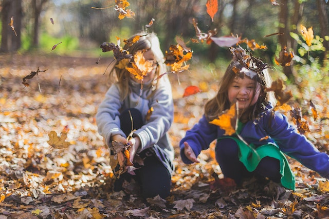 Children Playing Outside in the fall with leaves